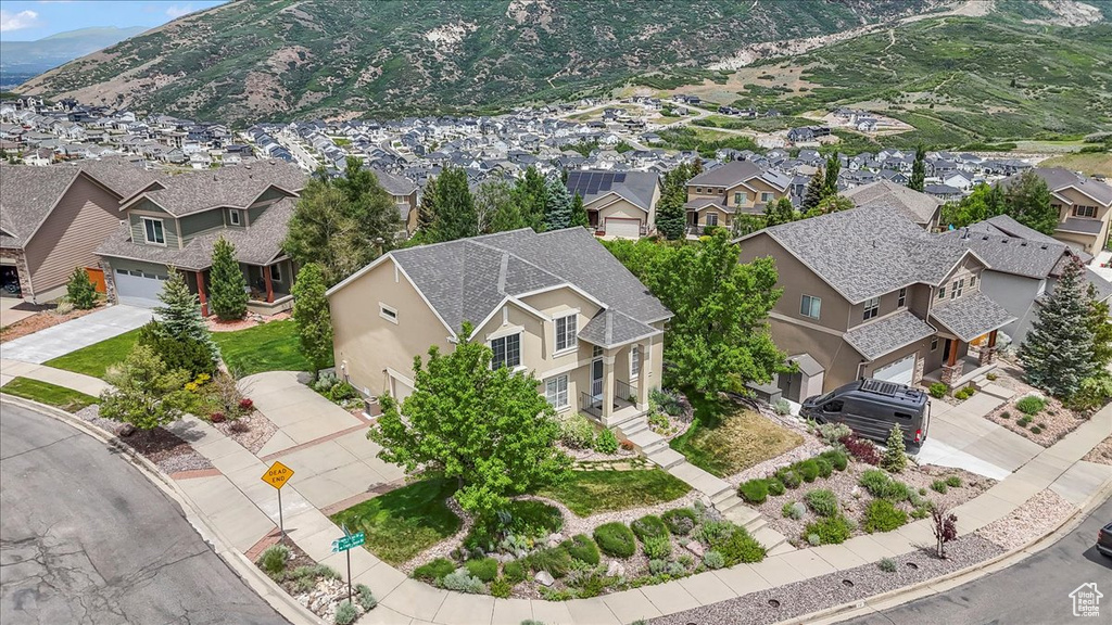Aerial view of residential area featuring a mountainous background