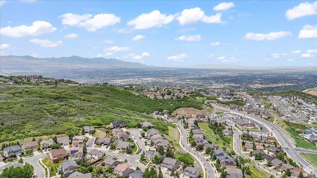 Aerial overview of property's location with nearby suburban area and a mountain backdrop
