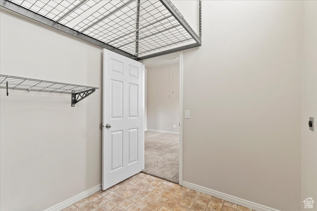 Spare room featuring baseboards and light carpet