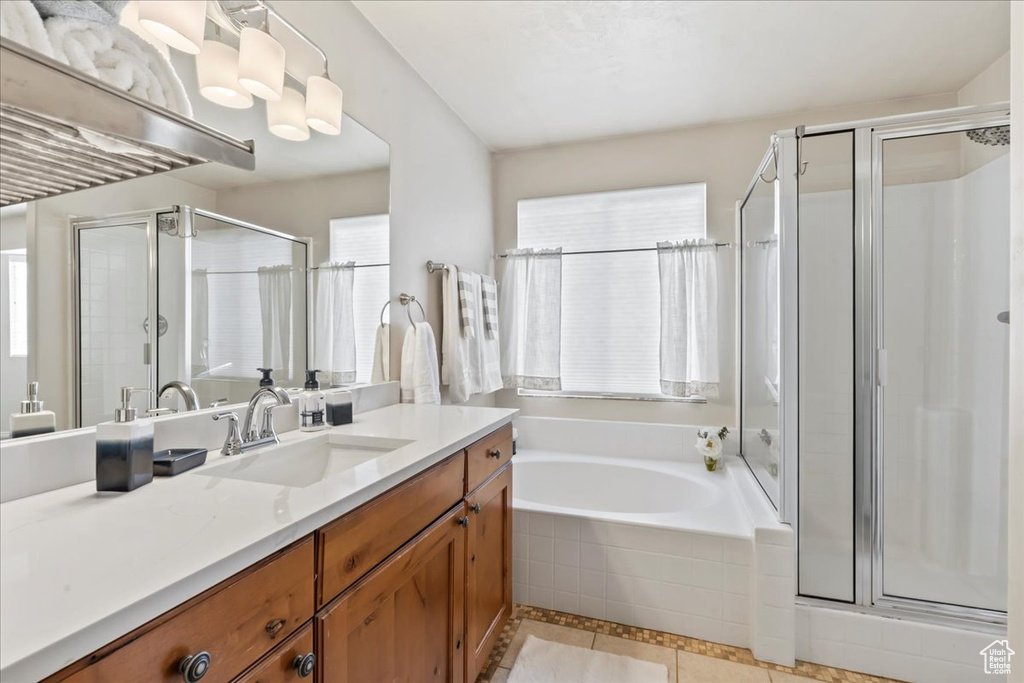 Full bath with vanity, a stall shower, tile patterned floors, and a bath