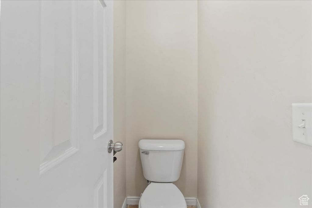 Bathroom with toilet and baseboards