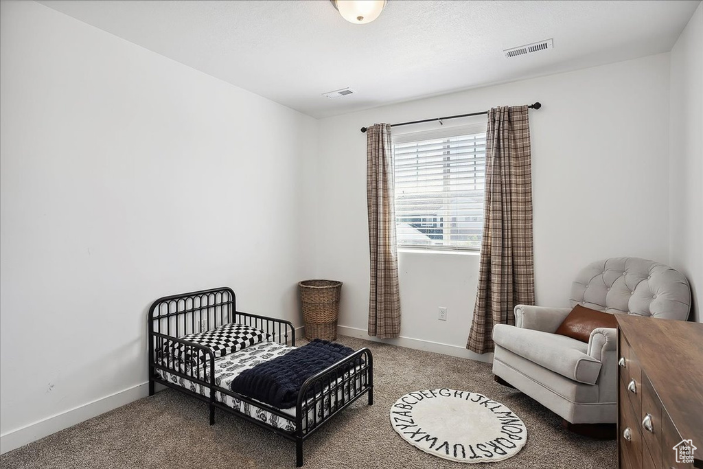 Carpeted bedroom featuring baseboards