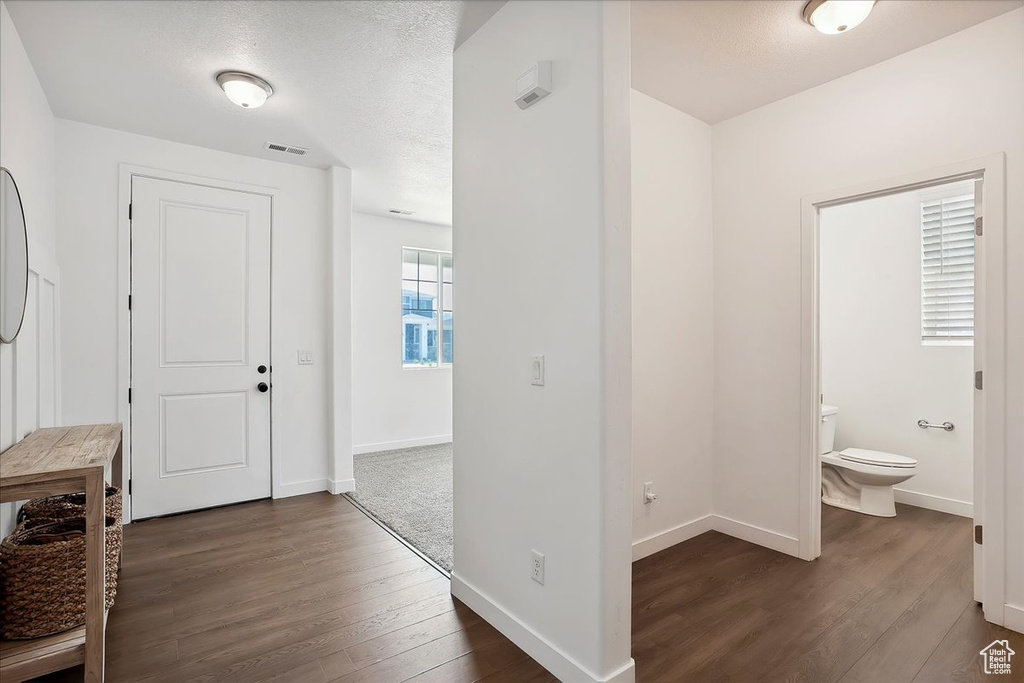 Entryway featuring dark wood-style floors and baseboards