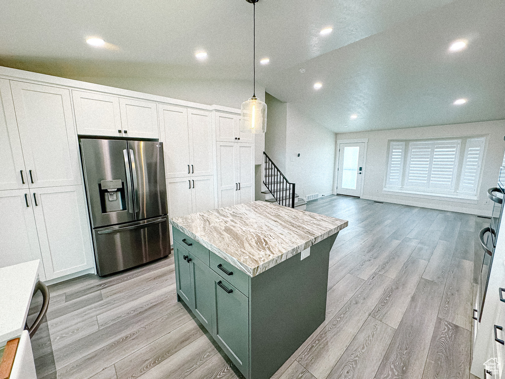 Kitchen with stainless steel fridge with ice dispenser, green cabinetry, light wood-style flooring, recessed lighting, and white cabinetry