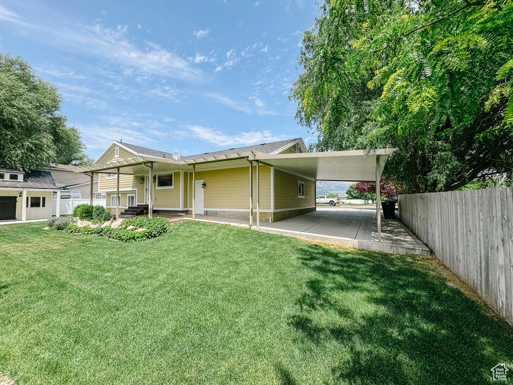 Back of property featuring an attached carport