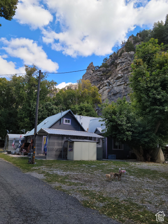 View of front of home featuring metal roof and central AC unit