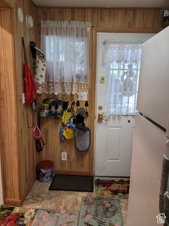 Doorway featuring wood walls