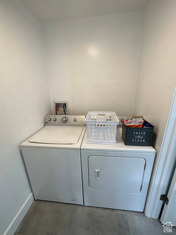 Washroom featuring washer and clothes dryer and baseboards