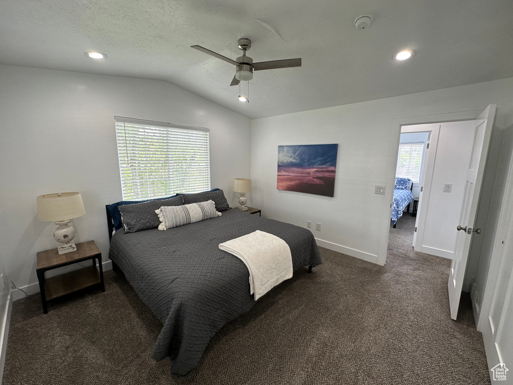 Carpeted bedroom featuring vaulted ceiling, baseboards, recessed lighting, and a ceiling fan