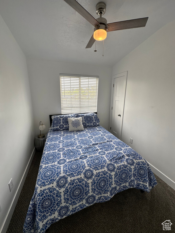 Bedroom featuring carpet, baseboards, and a ceiling fan