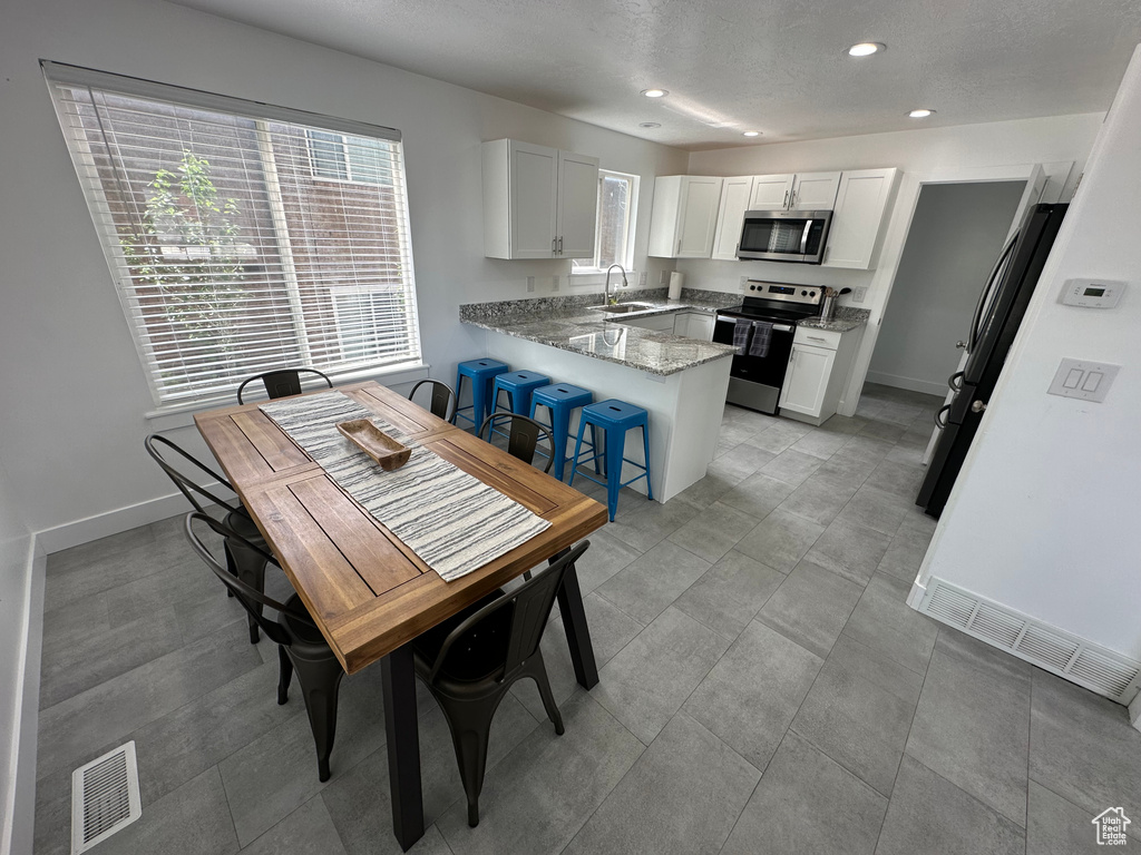 Dining space featuring recessed lighting and baseboards