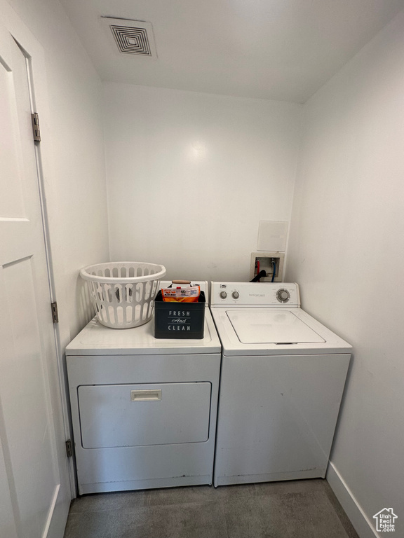 Washroom featuring separate washer and dryer and baseboards