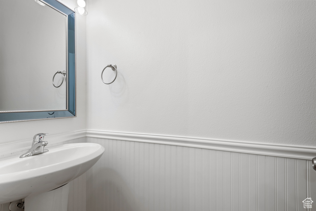 Bathroom with wainscoting and a sink