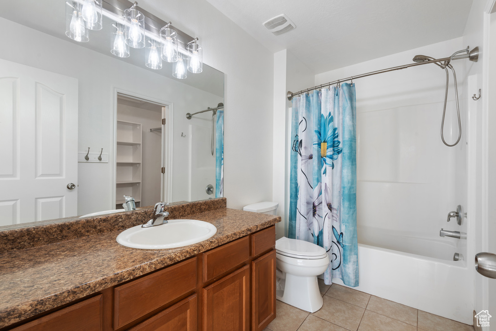 Full bathroom featuring vanity, shower / tub combo, tile patterned flooring, and toilet