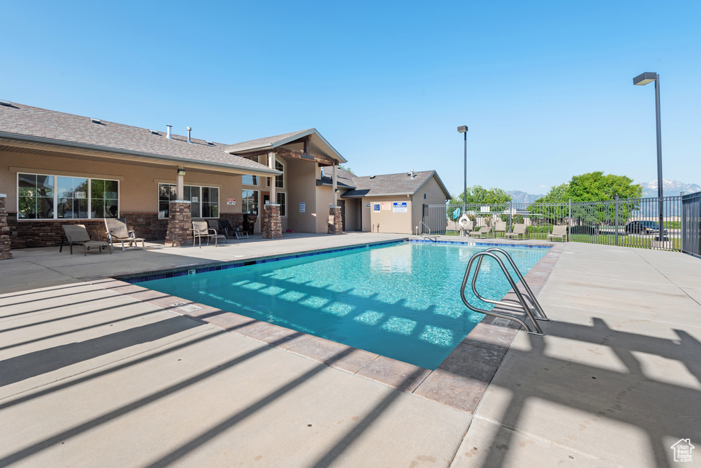 Community pool featuring a patio