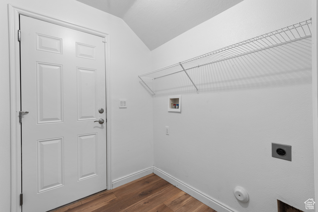 Laundry room featuring washer hookup, hookup for an electric dryer, dark wood-style floors, baseboards, and gas dryer hookup