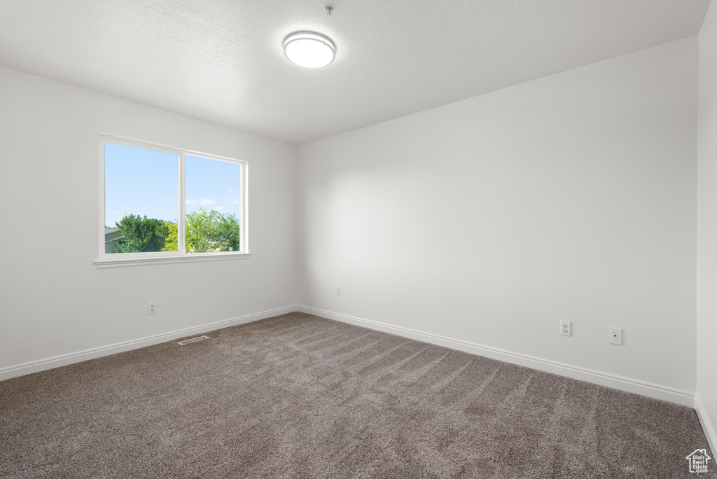 Spare room with carpet floors and baseboards
