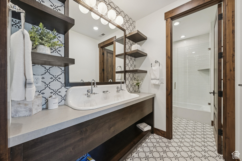 Bathroom with vanity,  shower combination, tasteful backsplash, recessed lighting, and baseboards