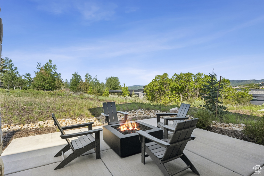 View of patio with an outdoor fire pit