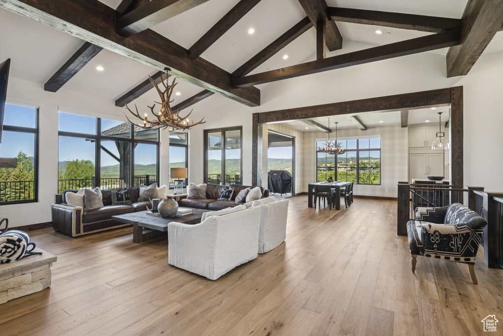 Living area with a chandelier, recessed lighting, and hardwood / wood-style flooring