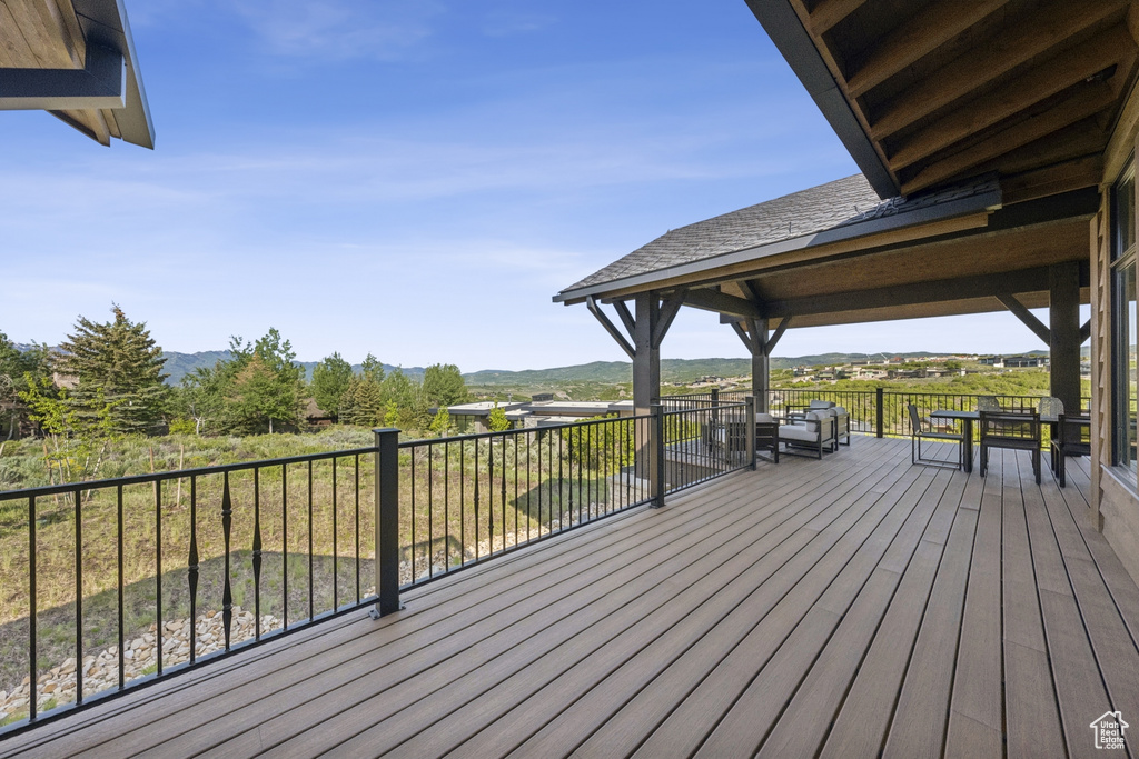Wooden terrace featuring a mountain view