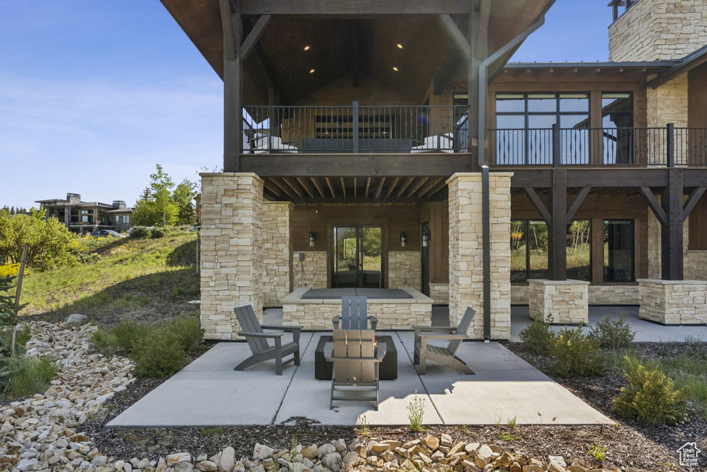 View of patio with a balcony