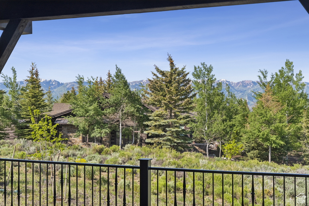 View of yard featuring a mountain view and a balcony