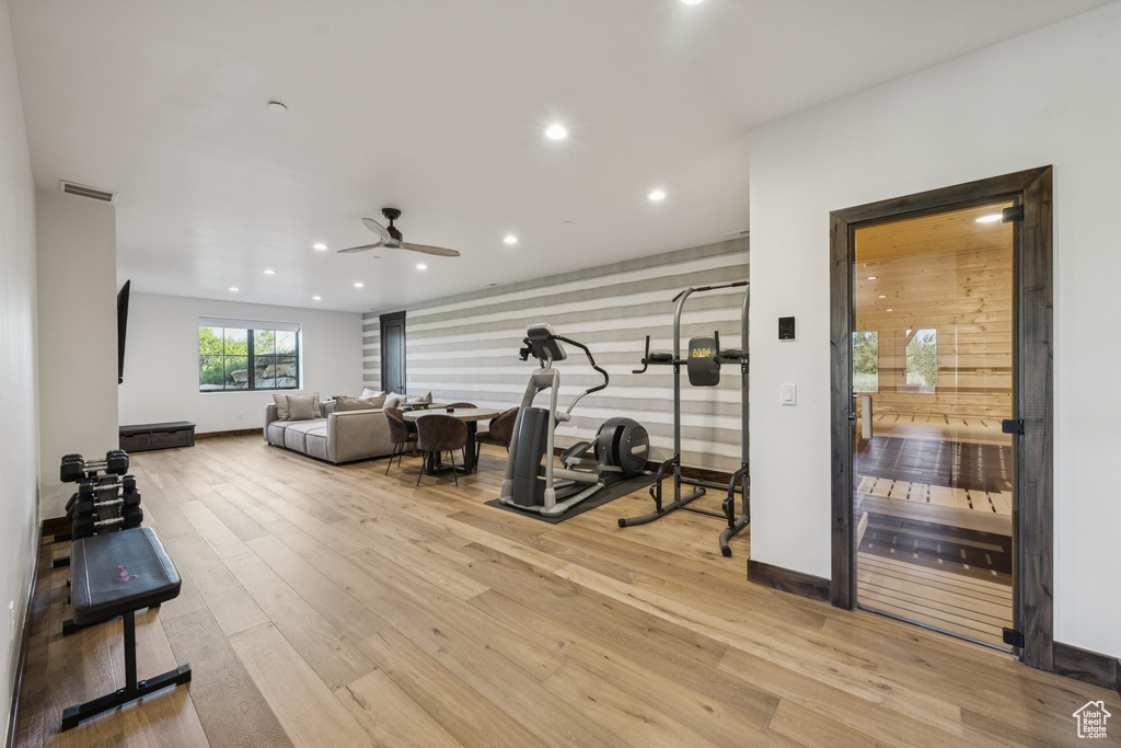 Exercise area with ceiling fan, recessed lighting, wood finished floors, and baseboards