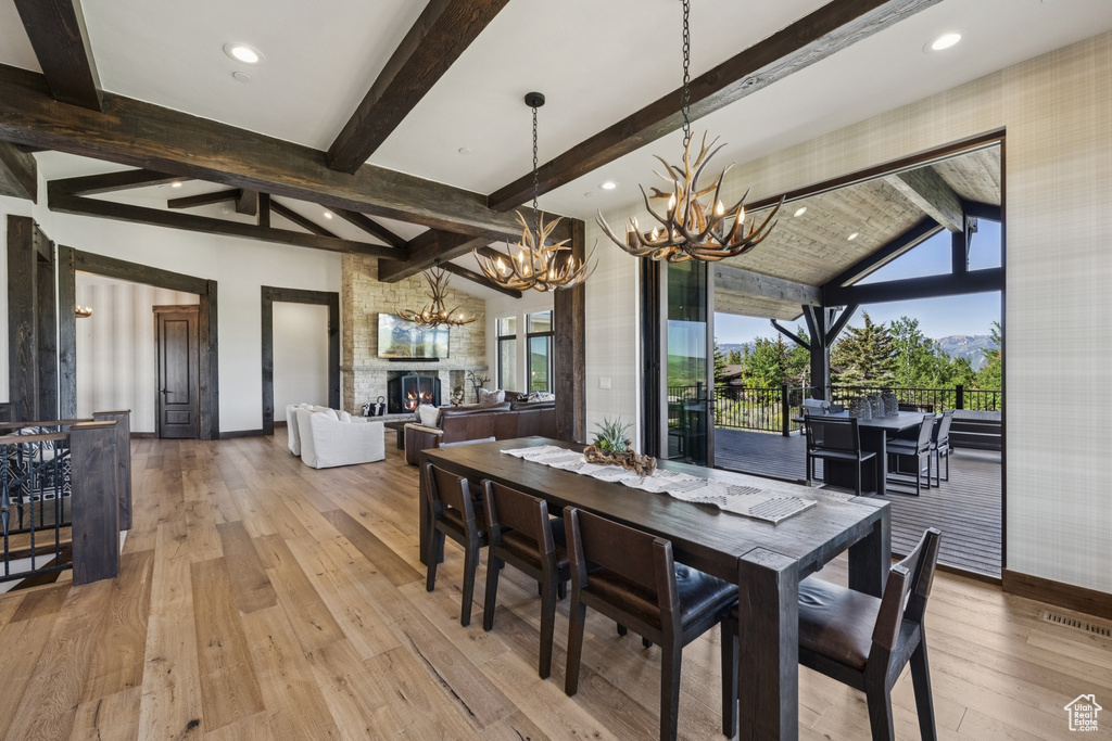 Dining area with a chandelier, baseboards, hardwood / wood-style floors, and recessed lighting