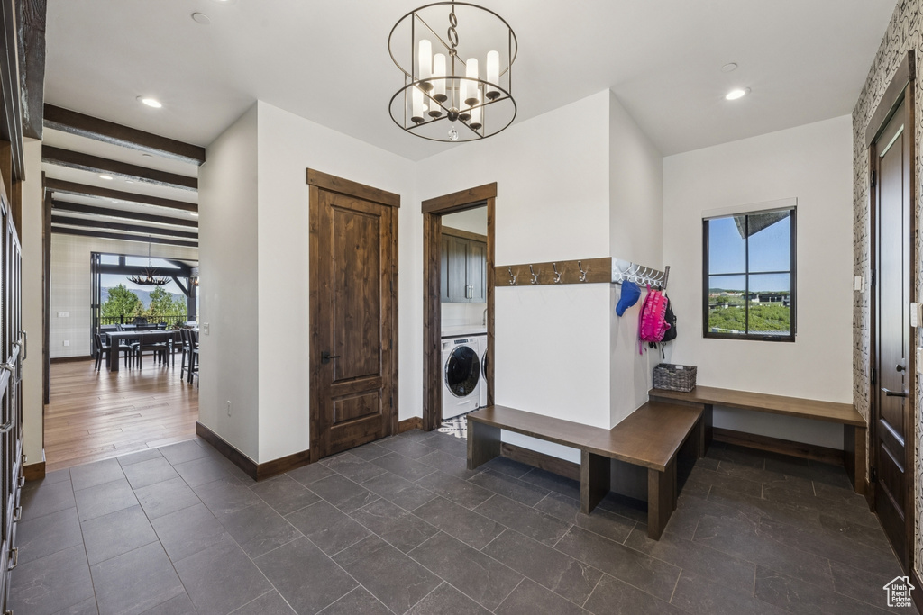 Entryway featuring washer / dryer, plenty of natural light, baseboards, a chandelier, and recessed lighting