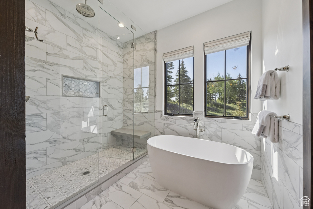 Full bath featuring a marble finish shower, a soaking tub, tile walls, marble finish floors, and recessed lighting