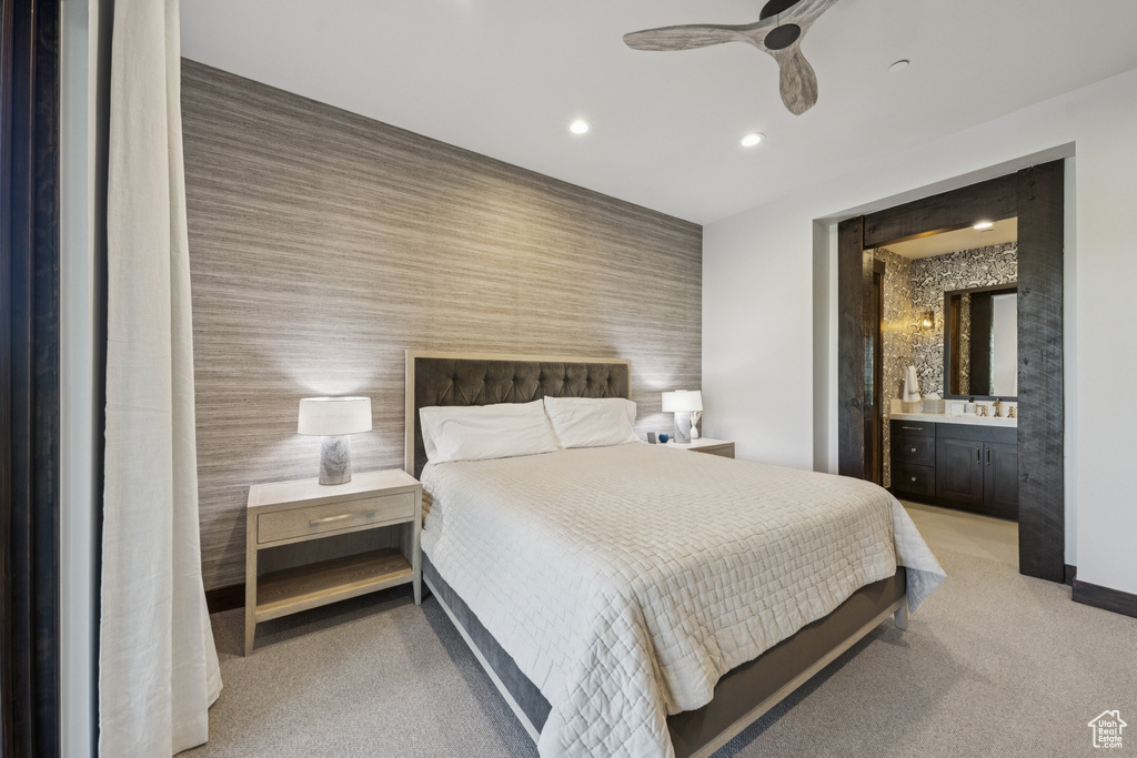 Bedroom with recessed lighting, light carpet, wallpapered walls, an accent wall, and bar
