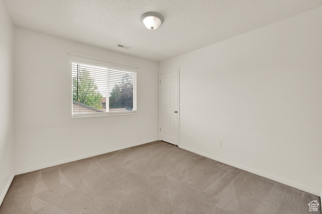 Empty room with carpet floors and baseboards