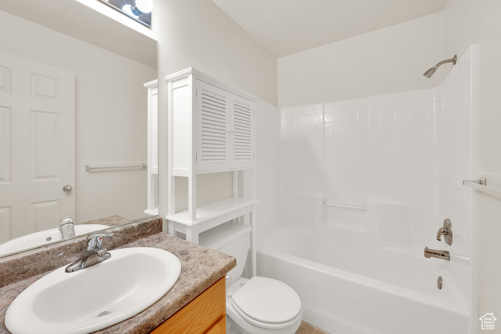 Full bath featuring vanity, washtub / shower combination, and toilet