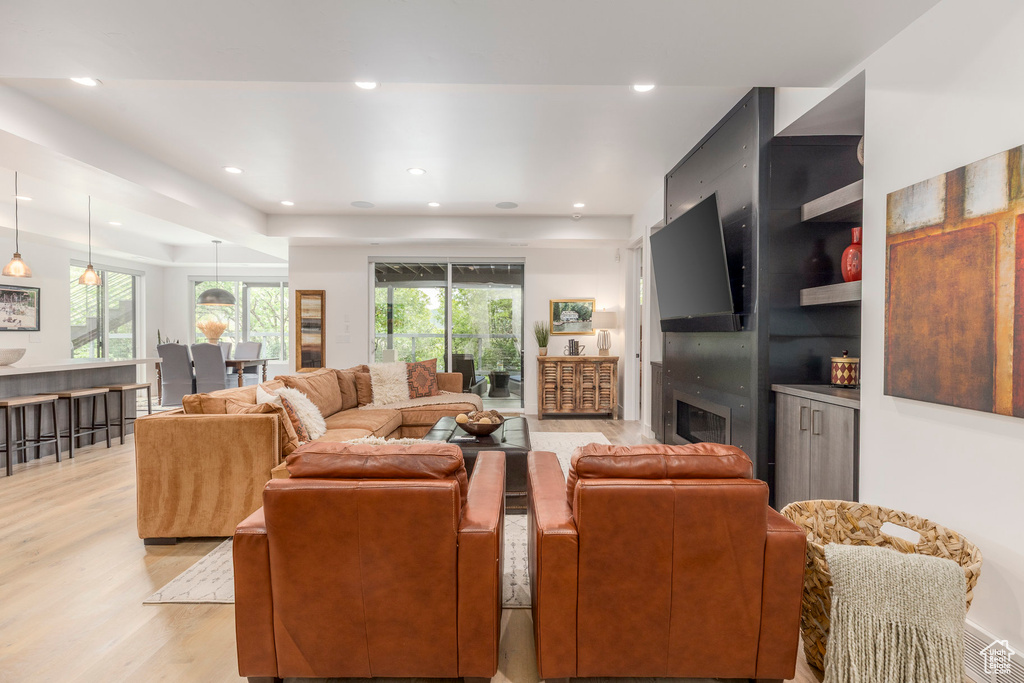 Living area featuring light wood-type flooring and recessed lighting
