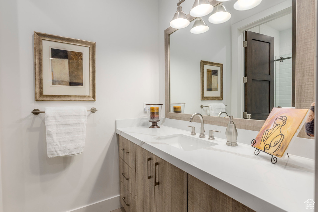 Bathroom featuring vanity and a chandelier