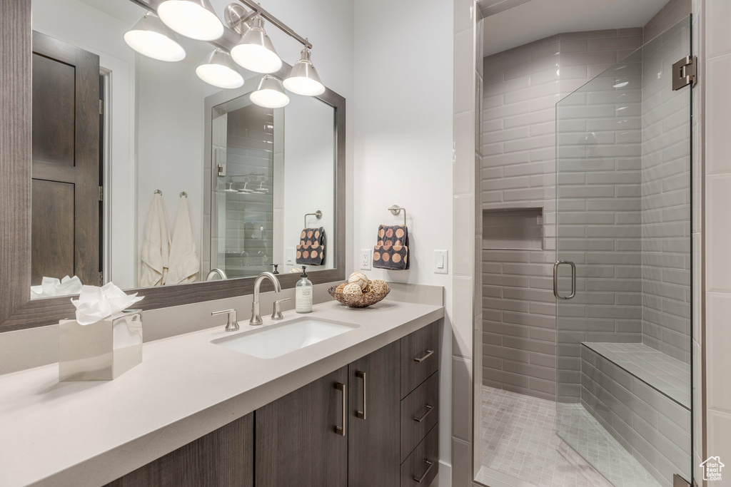 Bathroom featuring vanity and a shower stall