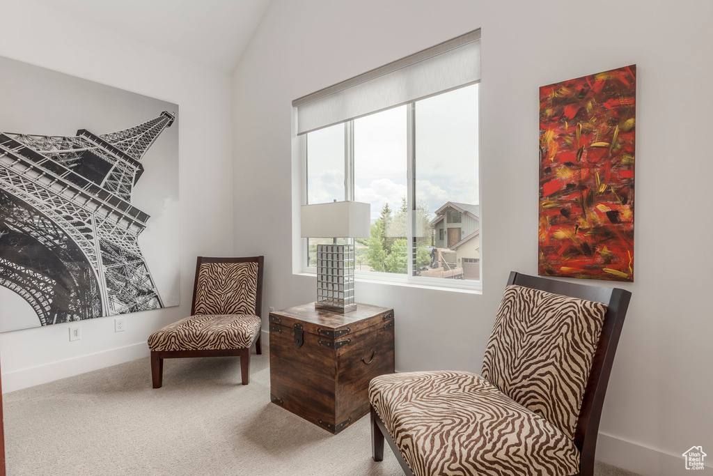 Sitting room featuring carpet flooring, lofted ceiling, and baseboards