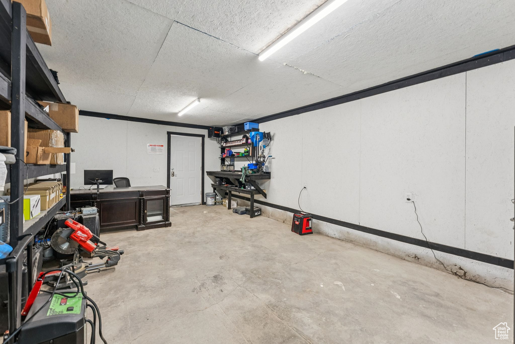 Basement featuring a textured ceiling