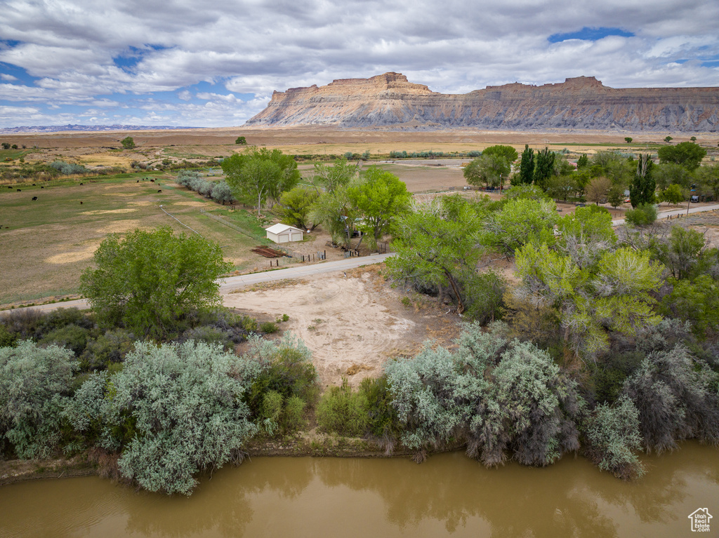 View of mountain background featuring a large body of water and rural landscape