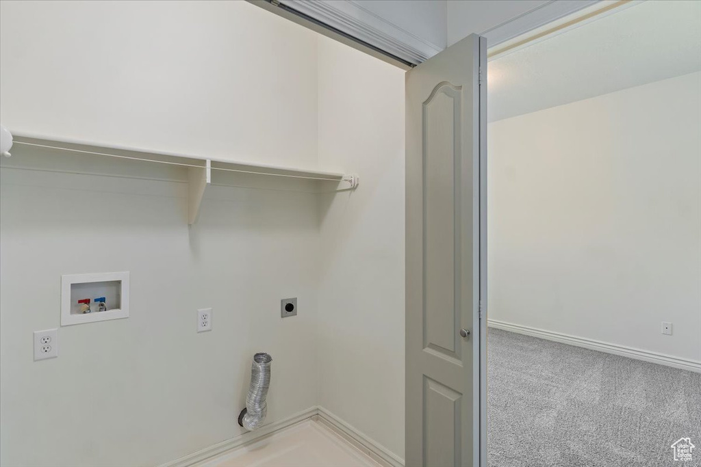 Laundry area featuring hookup for an electric dryer, hookup for a washing machine, light carpet, and baseboards