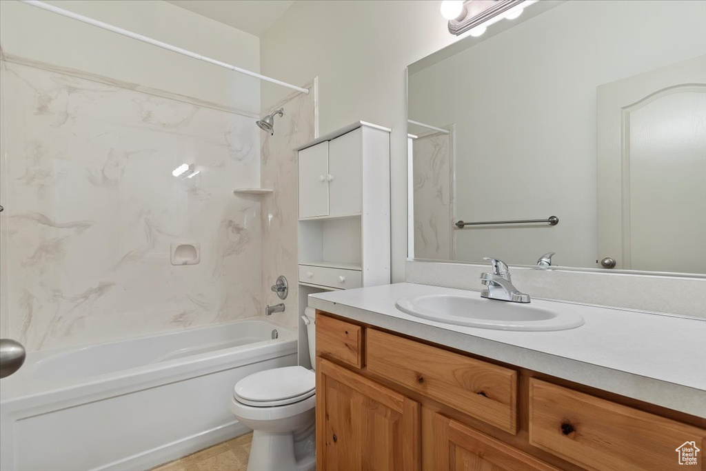 Bathroom featuring vanity, bathing tub / shower combination, toilet, and tile patterned floors