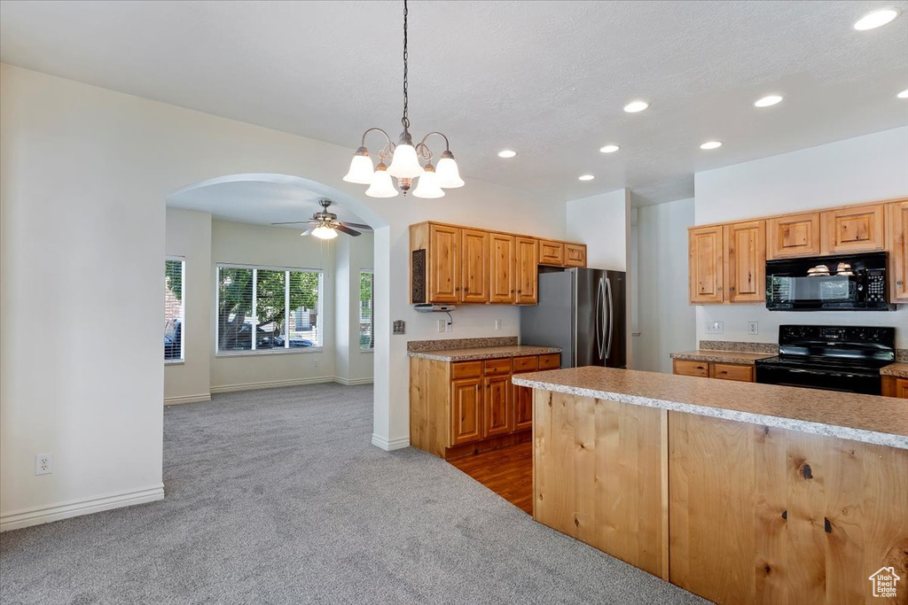 Kitchen with black appliances, recessed lighting, dark carpet, arched walkways, and a ceiling fan