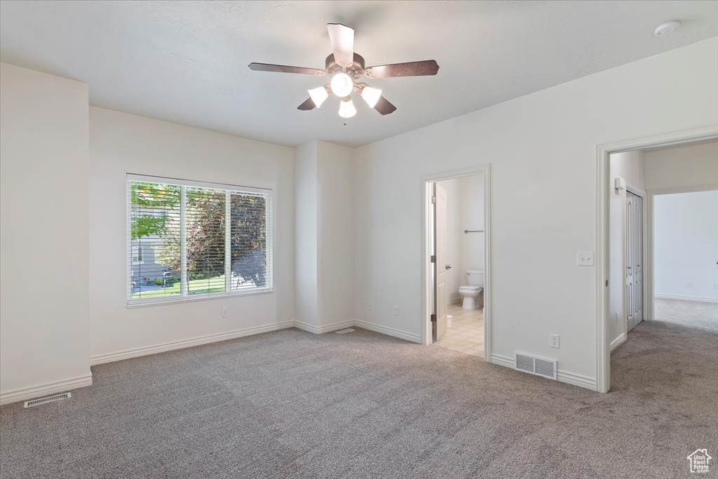 Unfurnished room with carpet flooring, a ceiling fan, baseboards, and a smoke detector