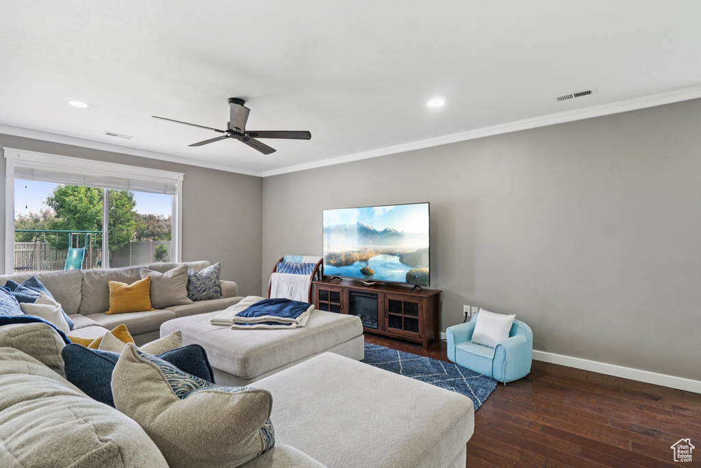 Living room with dark wood-type flooring, baseboards, crown molding, a ceiling fan, and recessed lighting