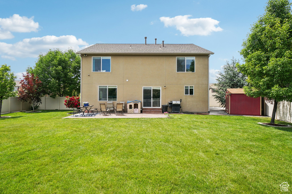 Rear view of house featuring a patio and stucco siding