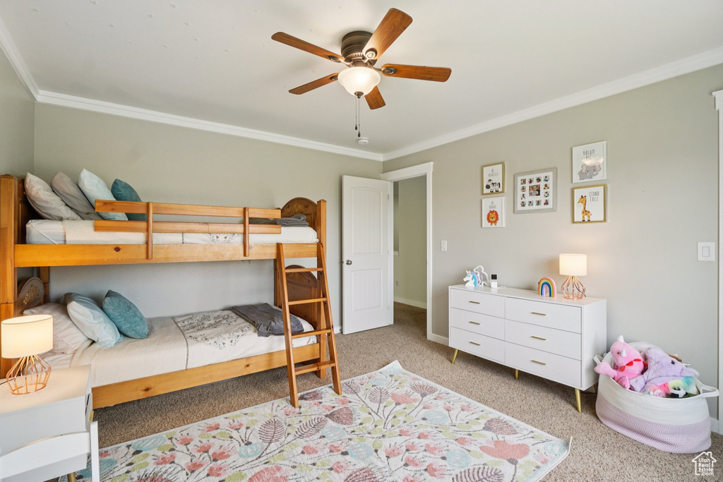 Bedroom featuring ornamental molding, light carpet, and a ceiling fan
