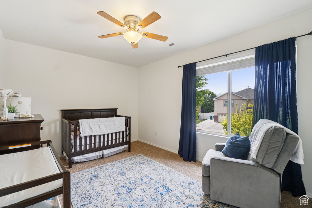 Carpeted bedroom with baseboards and ceiling fan