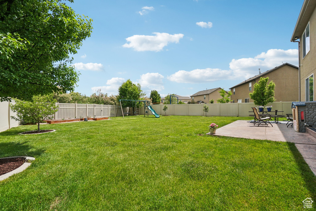 View of yard with a patio area and a playground