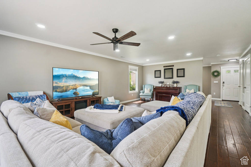 Living room featuring baseboards, recessed lighting, dark wood-type flooring, ornamental molding, and ceiling fan